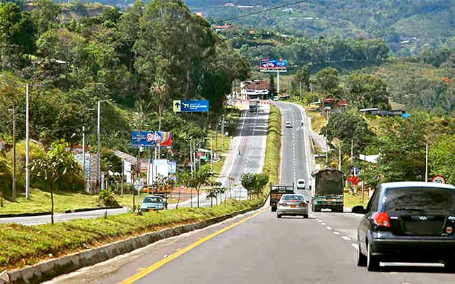 The Bogota to Melgar highway winding through tropical vegetation